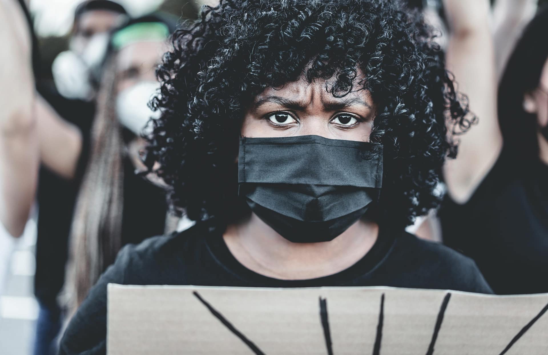 People from different culture and races protest on the street for equal rights - Demonstrators wearing face masks during black lives matter fight campaign - Main focus on mask